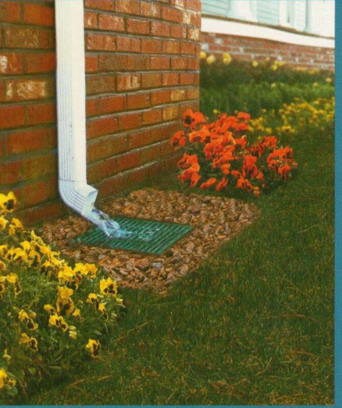 Downspout flowing into a surface drain — moving water away from the foundation