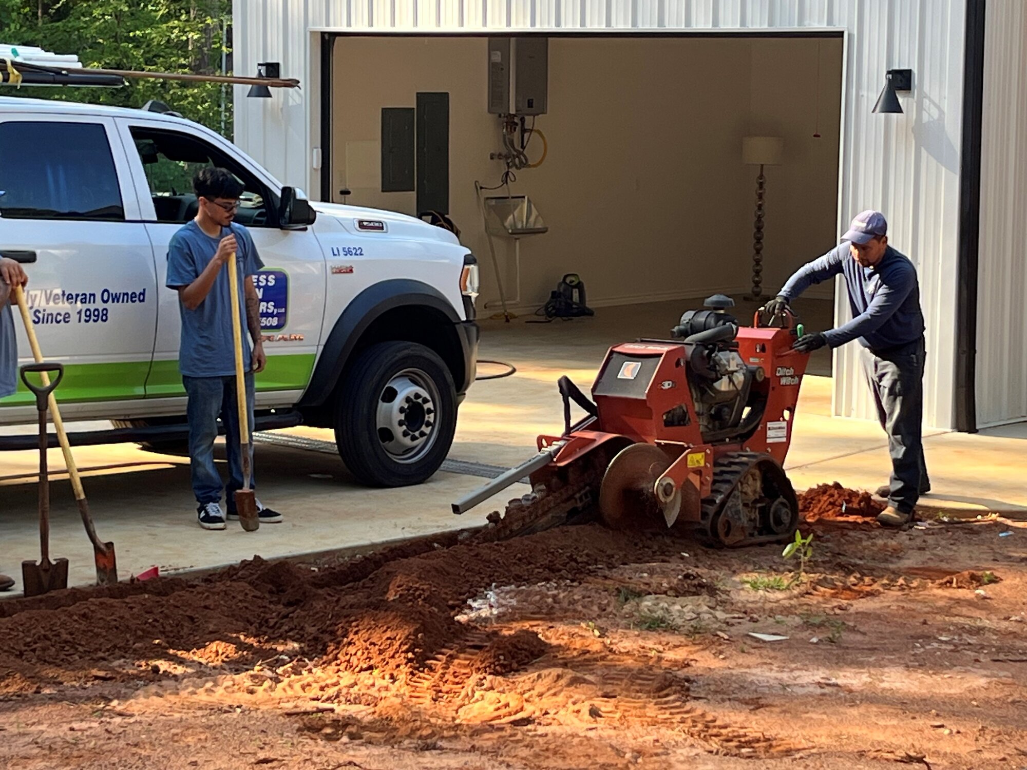 Express Lawn Sprinklers crew trenching for a new install — Tyler & East Texas.